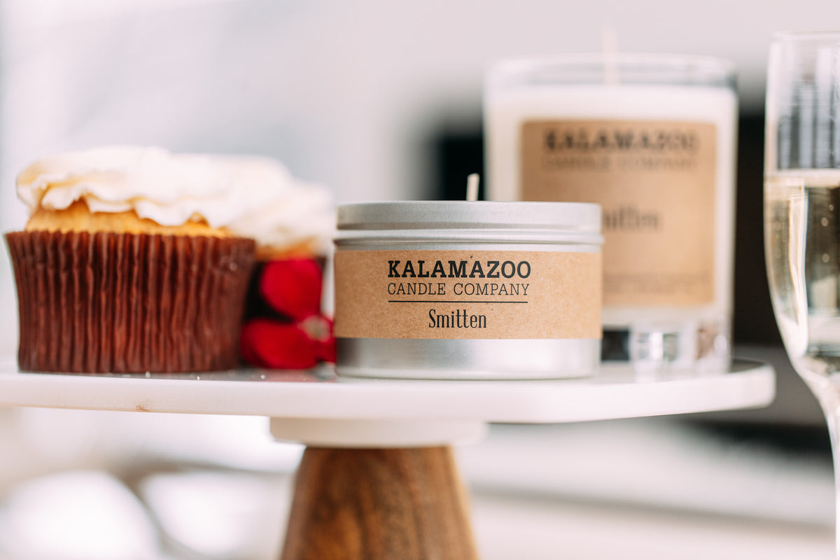 Smitten tin and jar next to baked goods