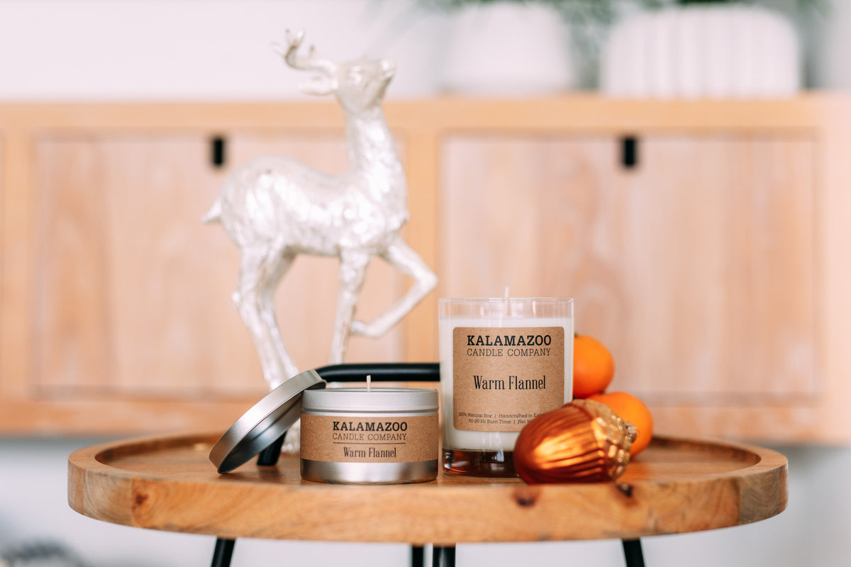 Two Warm Flannel Candles on a wooden table