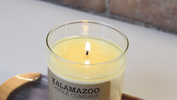 GIF of a candle being extinguished with a wick dipper
