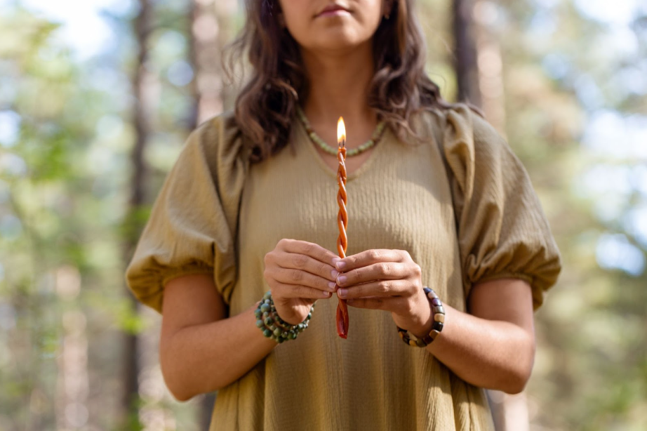 woman holding candle, explaining candle facts