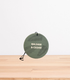 A Balsam & Cedar Car Freshener on a wooden table.