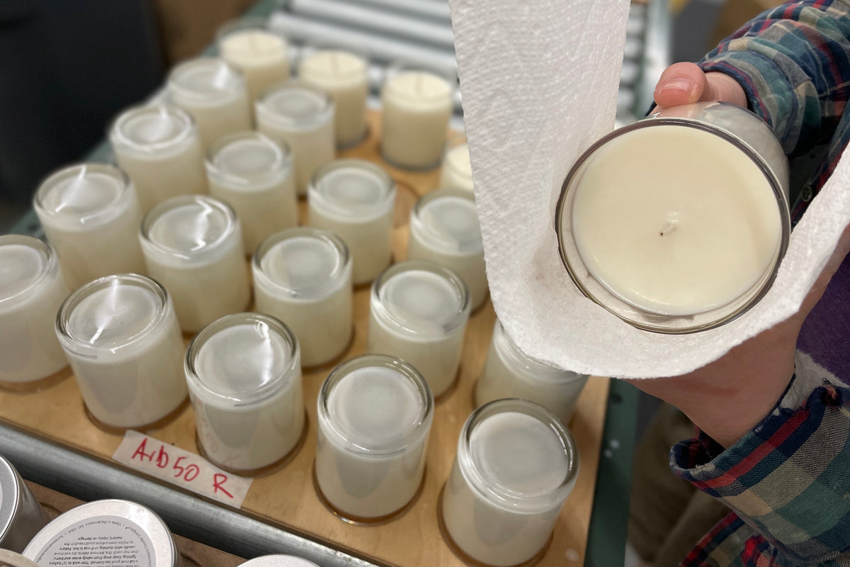 A person hand wiping a candle