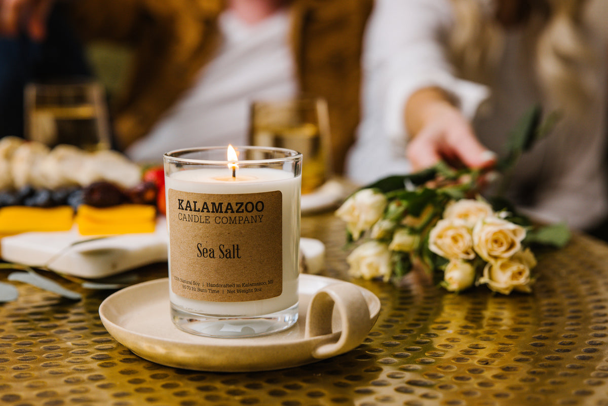 Sea Salt Candle in front of a charcuterie board
