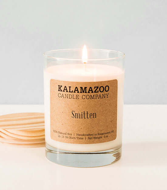 Smitten Candles A soft, sweet blend of floaty florls, sparkling citrus and creamy vanilla, this classic soy candle smells like sunshine daydreams. All Kalamazoo Candles are: 100% natural scented soy wax; produced using locally sourced and American-made ma